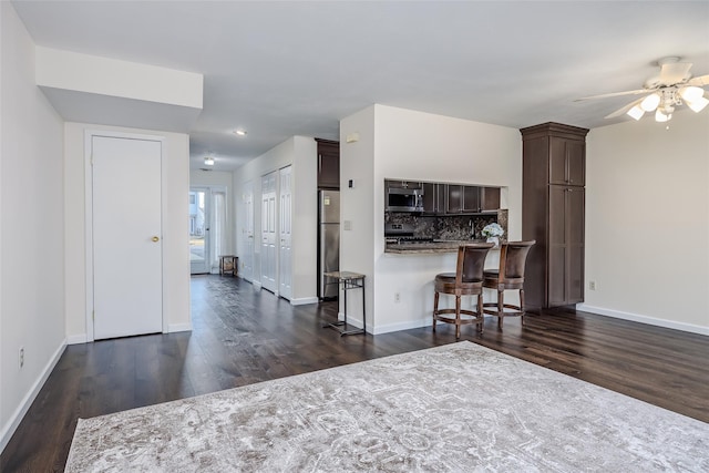 903 Sara Cir Unit 903, Port Jefferson Station, NY 11776 - kitchen featuring stainless steel appliances, dark wood finished floors, dark brown cabinets, decorative backsplash, and recessed lighting