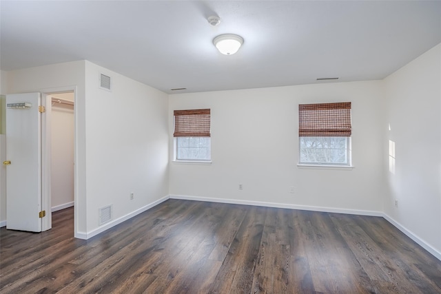 903 Sara Cir Unit 903, Port Jefferson Station, NY 11776 - unfurnished bedroom featuring a walk in closet, dark wood finished floors, and baseboards