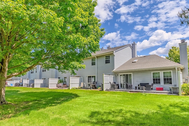 903 Sara Cir Unit 903, Port Jefferson Station, NY 11776 - rear view of house featuring a lawn, a chimney, and a patio area