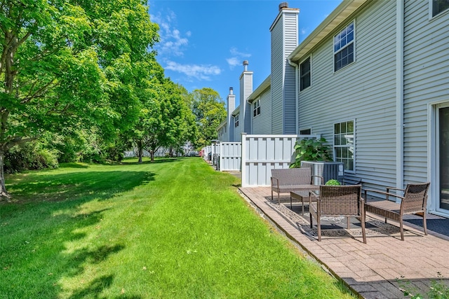 903 Sara Cir Unit 903, Port Jefferson Station, NY 11776 - view of green lawn with a patio area and central AC unit