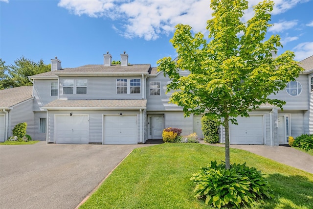 903 Sara Cir Unit 903, Port Jefferson Station, NY 11776 - view of property with driveway, a front lawn, a chimney, and a garage