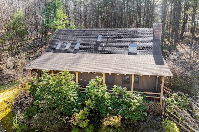 79 Torre Rock Rd, Red Hook, NY 12571 - rear view of house with a chimney, a shingled roof, and a view of trees