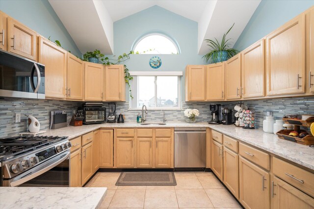 720 W Park Ave, Long Beach, NY 11561 - kitchen featuring light tile patterned floors, light brown cabinets, a sink, and appliances with stainless steel finishes