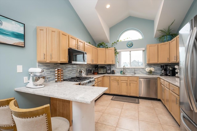 720 W Park Ave, Long Beach, NY 11561 - kitchen featuring a peninsula, light brown cabinetry, appliances with stainless steel finishes, a sink, and backsplash
