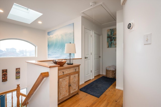 720 W Park Ave, Long Beach, NY 11561 - hallway with recessed lighting, an upstairs landing, attic access, light wood-style floors, and a skylight