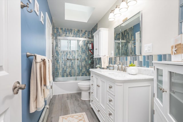 720 W Park Ave, Long Beach, NY 11561 - full bath featuring shower / bath combination with glass door, vanity, toilet, a skylight, and wood finished floors