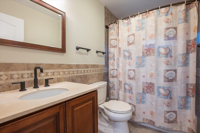 720 W Park Ave, Long Beach, NY 11561 - bathroom featuring vanity, tile patterned flooring, toilet, wainscoting, and tile walls
