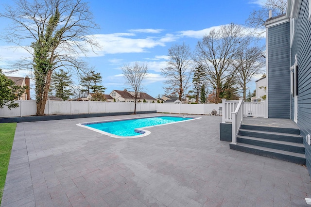 view of pool featuring a fenced backyard, a fenced in pool, a deck, and a patio area