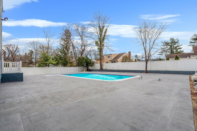 view of pool featuring a fenced in pool, a fenced backyard, and a patio area