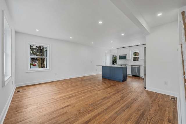 unfurnished living room featuring visible vents, baseboards, light wood-style floors, and recessed lighting