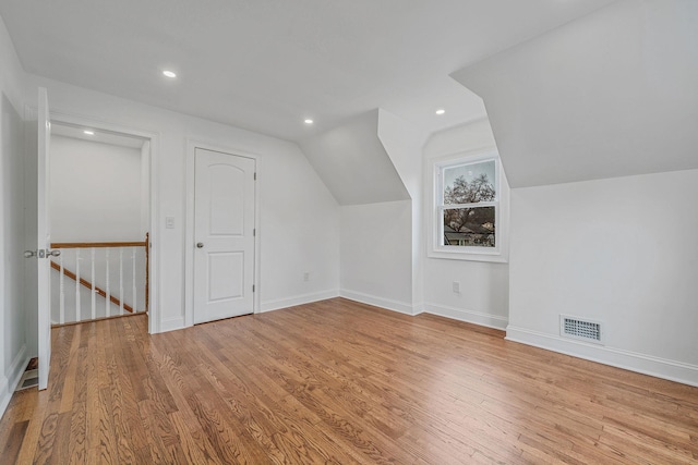 bonus room featuring visible vents, wood finished floors, recessed lighting, and vaulted ceiling