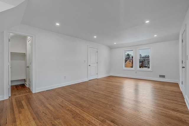 interior space featuring visible vents, baseboards, recessed lighting, and wood finished floors