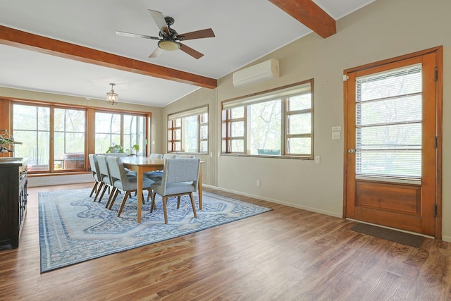dining space with a healthy amount of sunlight, vaulted ceiling with beams, a wall unit AC, and wood finished floors