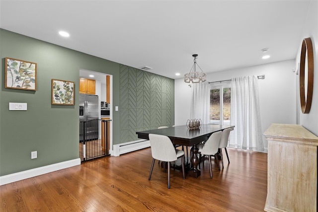 dining room with a baseboard heating unit, recessed lighting, a chandelier, and dark wood finished floors