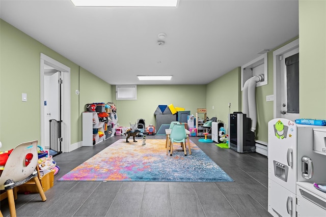 playroom featuring a baseboard heating unit