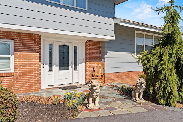 property entrance with brick siding
