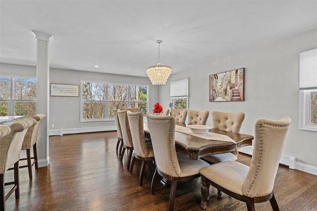 dining room with a wealth of natural light, a notable chandelier, a baseboard heating unit, and baseboards
