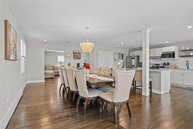 dining space with baseboards, dark wood-style flooring, a chandelier, baseboard heating, and recessed lighting