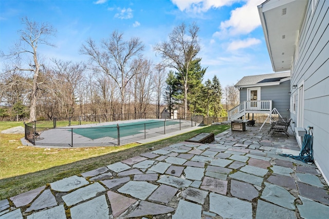 view of pool featuring a patio area, a fenced in pool, fence, and a lawn
