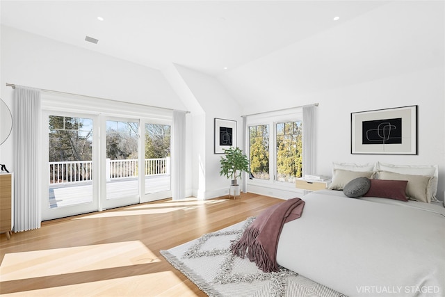 25 Fresh Pond Rd, North Haven, NY 11963 - bedroom with recessed lighting, access to exterior, lofted ceiling, and wood finished floors