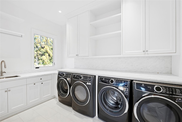 25 Fresh Pond Rd, North Haven, NY 11963 - clothes washing area with a sink, cabinet space, independent washer and dryer, and light tile patterned flooring