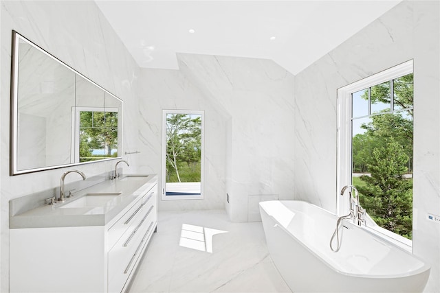 25 Fresh Pond Rd, North Haven, NY 11963 - bathroom with marble finish floor, a sink, double vanity, and a freestanding bath