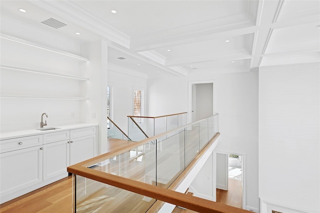 25 Fresh Pond Rd, North Haven, NY 11963 - hallway featuring visible vents, crown molding, beam ceiling, a sink, and light wood-style floors