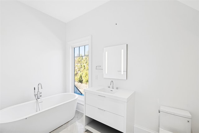 25 Fresh Pond Rd, North Haven, NY 11963 - bathroom with a freestanding tub, marble finish floor, toilet, and vanity