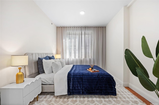 bedroom featuring baseboards and light wood-type flooring