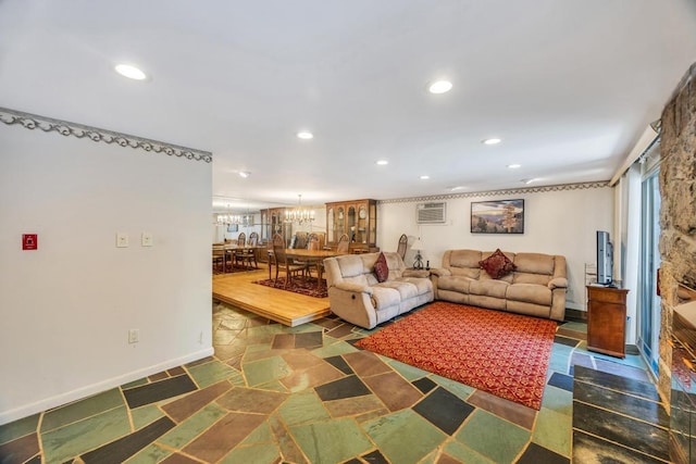 living area featuring baseboards, a wall mounted AC, recessed lighting, and a notable chandelier