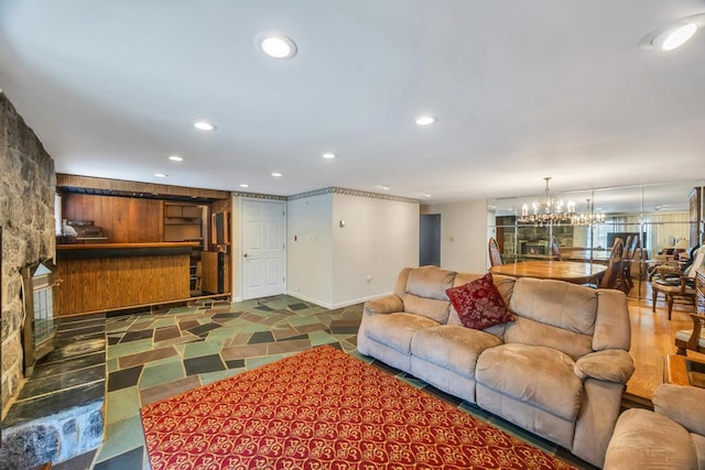 living room with an inviting chandelier, recessed lighting, and baseboards
