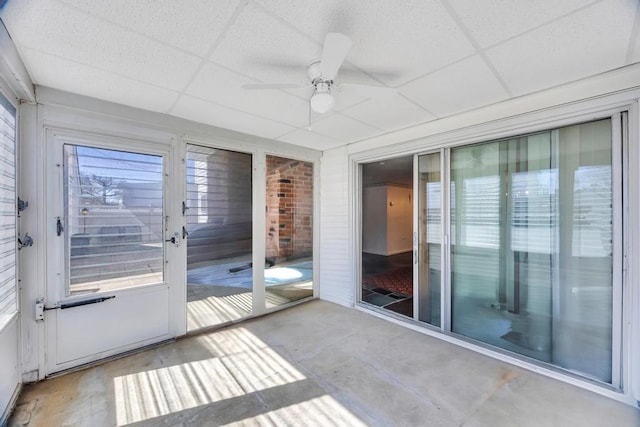 unfurnished sunroom featuring a ceiling fan
