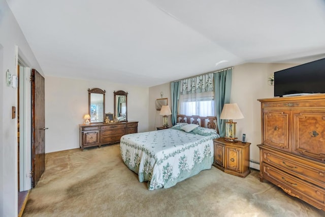 bedroom with light colored carpet, a baseboard radiator, and vaulted ceiling