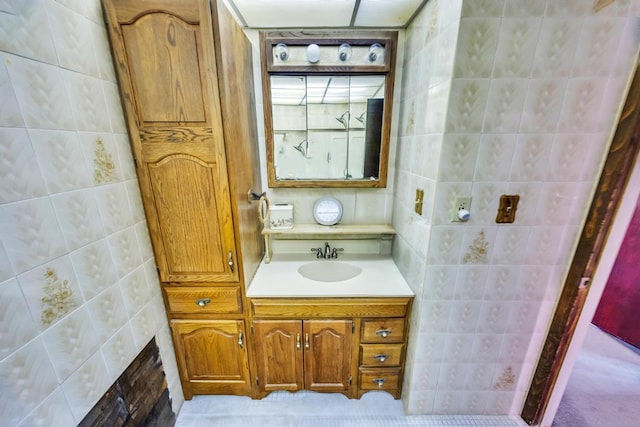 bathroom with tile walls and vanity