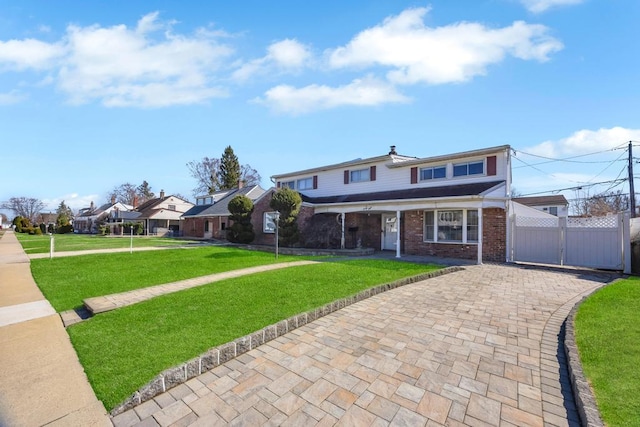 38 Cliff Ln, Levittown, NY 11756 - view of front facade featuring a gate, brick siding, driveway, and a porch