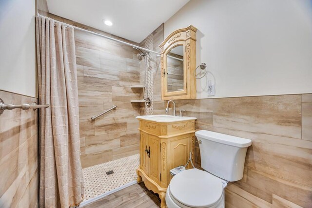 38 Cliff Ln, Levittown, NY 11756 - bathroom with tile walls, tiled shower, toilet, vanity, and wood finished floors
