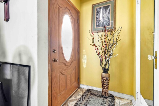 183-65 Elmira Ave, Saint Albans, NY 11412 - entryway with light tile patterned flooring and baseboards
