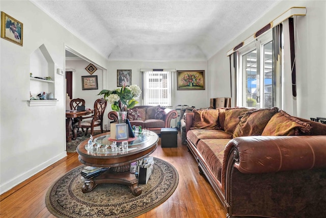 183-65 Elmira Ave, Saint Albans, NY 11412 - living area with hardwood / wood-style floors, baseboards, built in shelves, and a textured ceiling