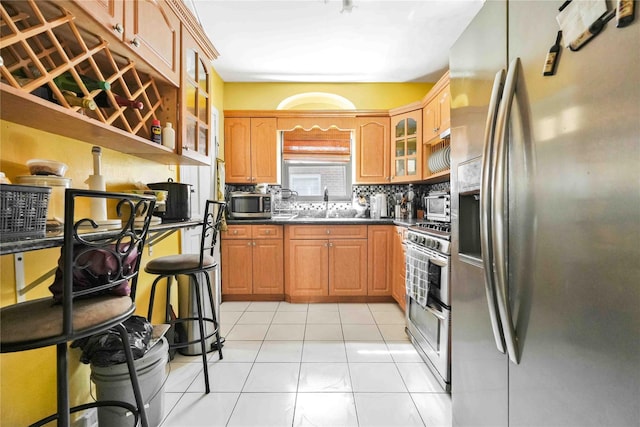 183-65 Elmira Ave, Saint Albans, NY 11412 - kitchen featuring a sink, appliances with stainless steel finishes, glass insert cabinets, dark countertops, and decorative backsplash