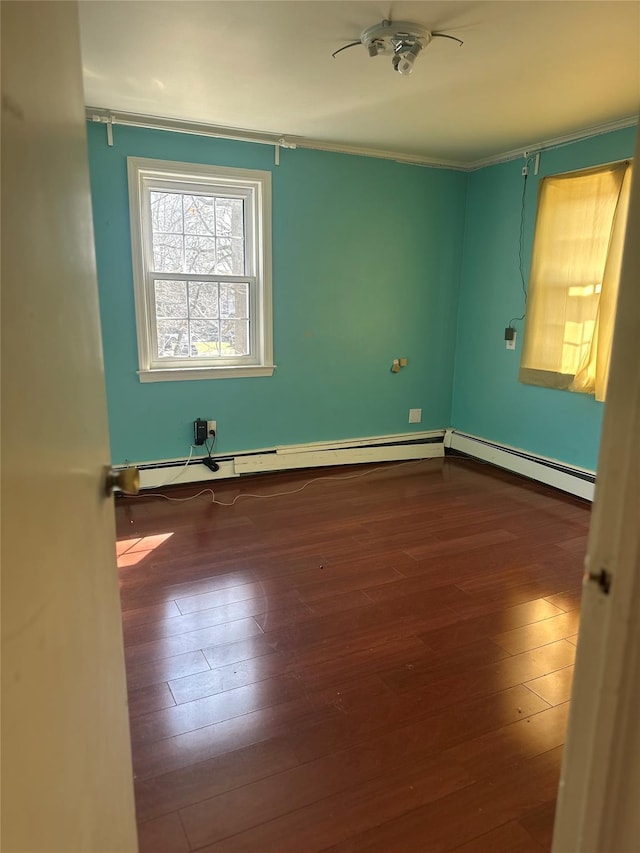 122 Finucane Pl, Woodmere, NY 11598 - unfurnished room featuring baseboard heating, crown molding, and dark wood finished floors
