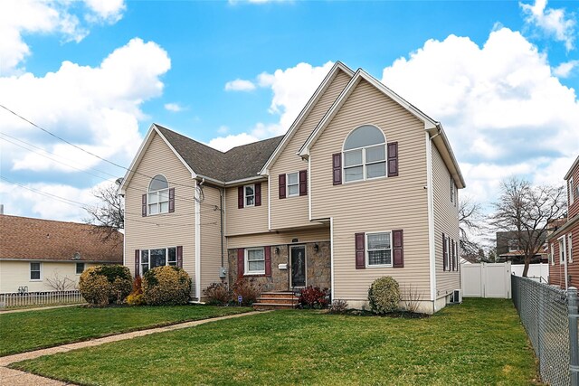 traditional-style home with a fenced backyard and a front yard