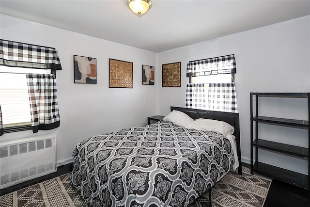 bedroom with radiator and baseboards