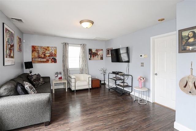 living area featuring visible vents and wood finished floors