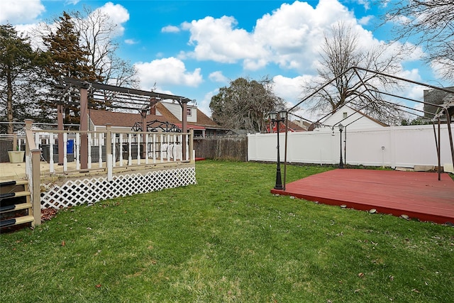 view of yard featuring a fenced backyard, a deck, and a pergola