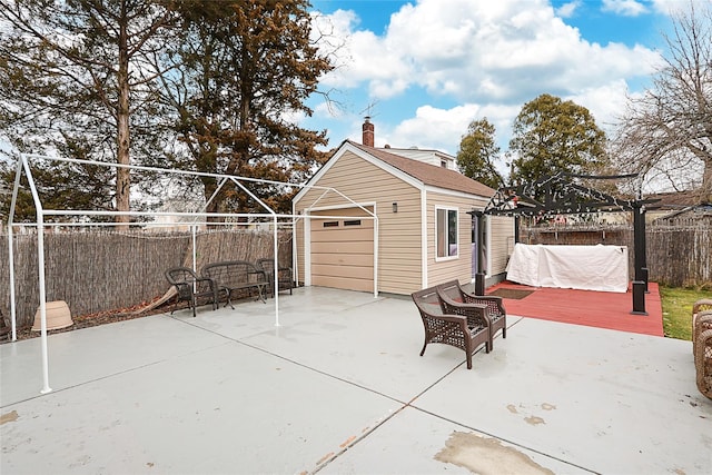 view of patio / terrace with fence, a wooden deck, and an outdoor structure