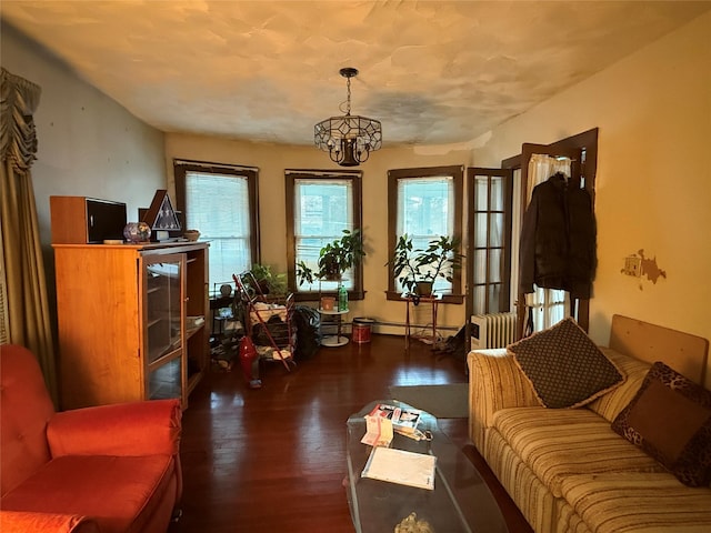 39 Rathbun Ave, White Plains, NY 10606 - living room with an inviting chandelier, radiator, a baseboard heating unit, and wood finished floors