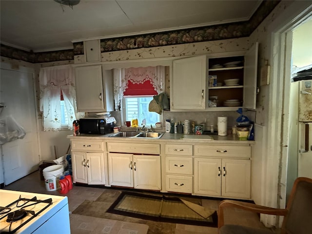 39 Rathbun Ave, White Plains, NY 10606 - kitchen with white cabinetry, black microwave, a sink, and white gas range oven