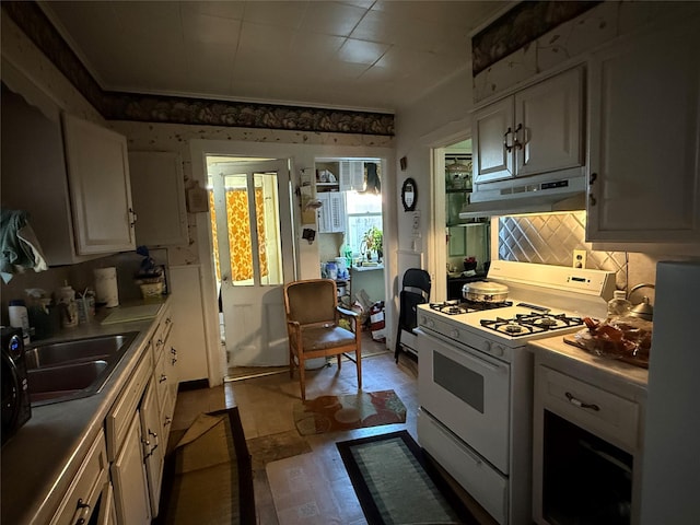 39 Rathbun Ave, White Plains, NY 10606 - kitchen with light countertops, white gas range, tasteful backsplash, under cabinet range hood, and a sink
