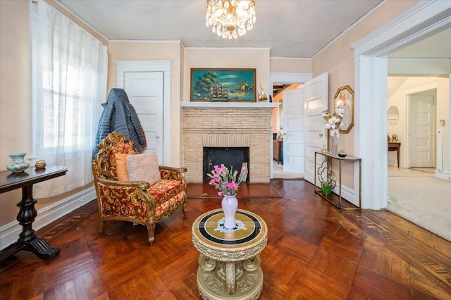 living area with a fireplace, ornamental molding, and a chandelier