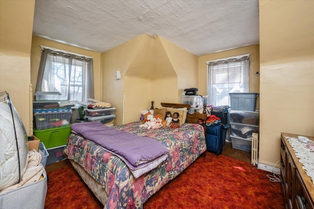 bedroom featuring carpet floors and a textured ceiling